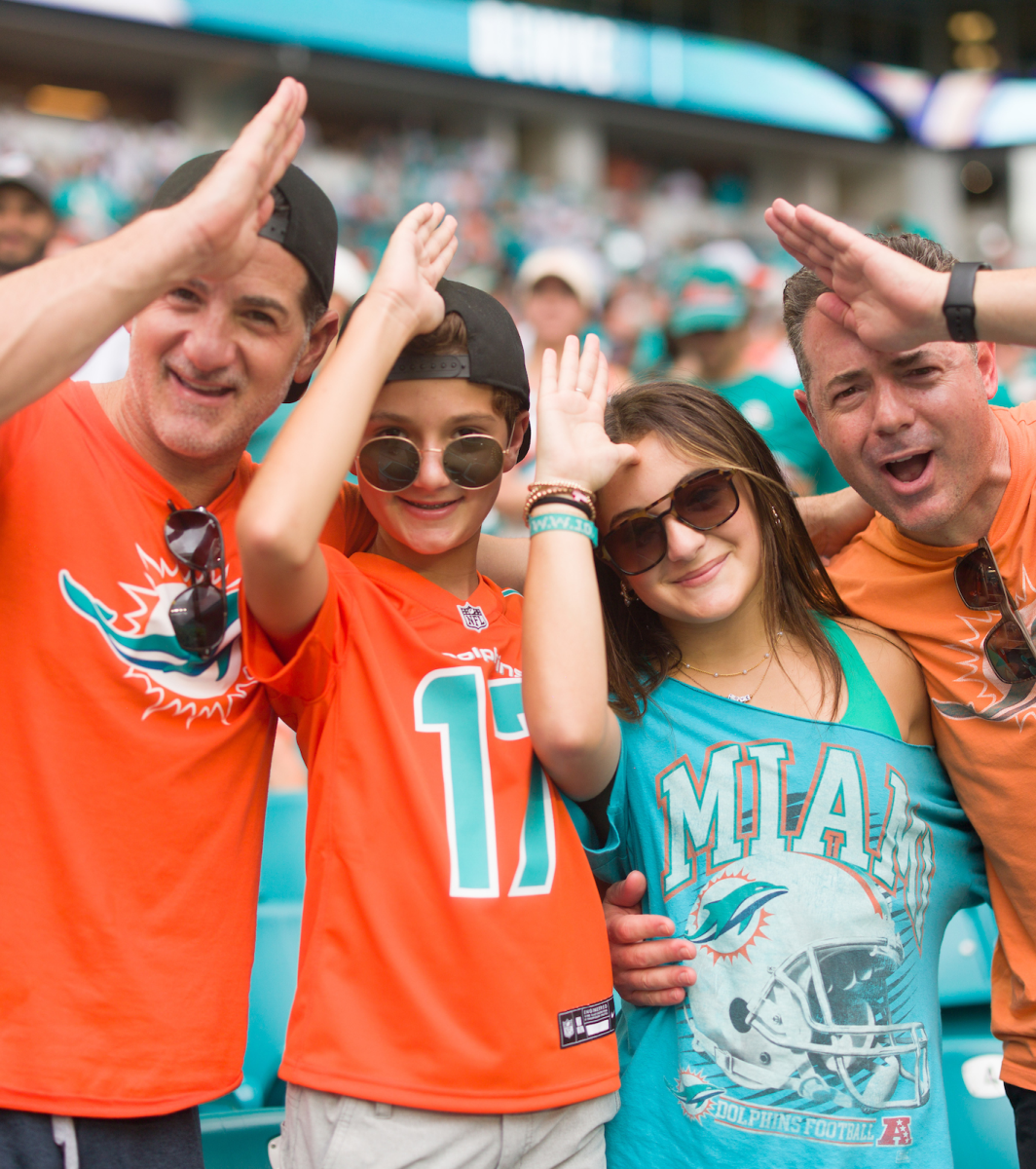 A family of 4 making dolphin fans.