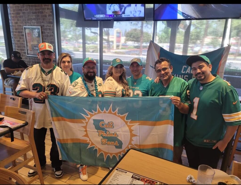 Cali Phins Fans holding up club flag