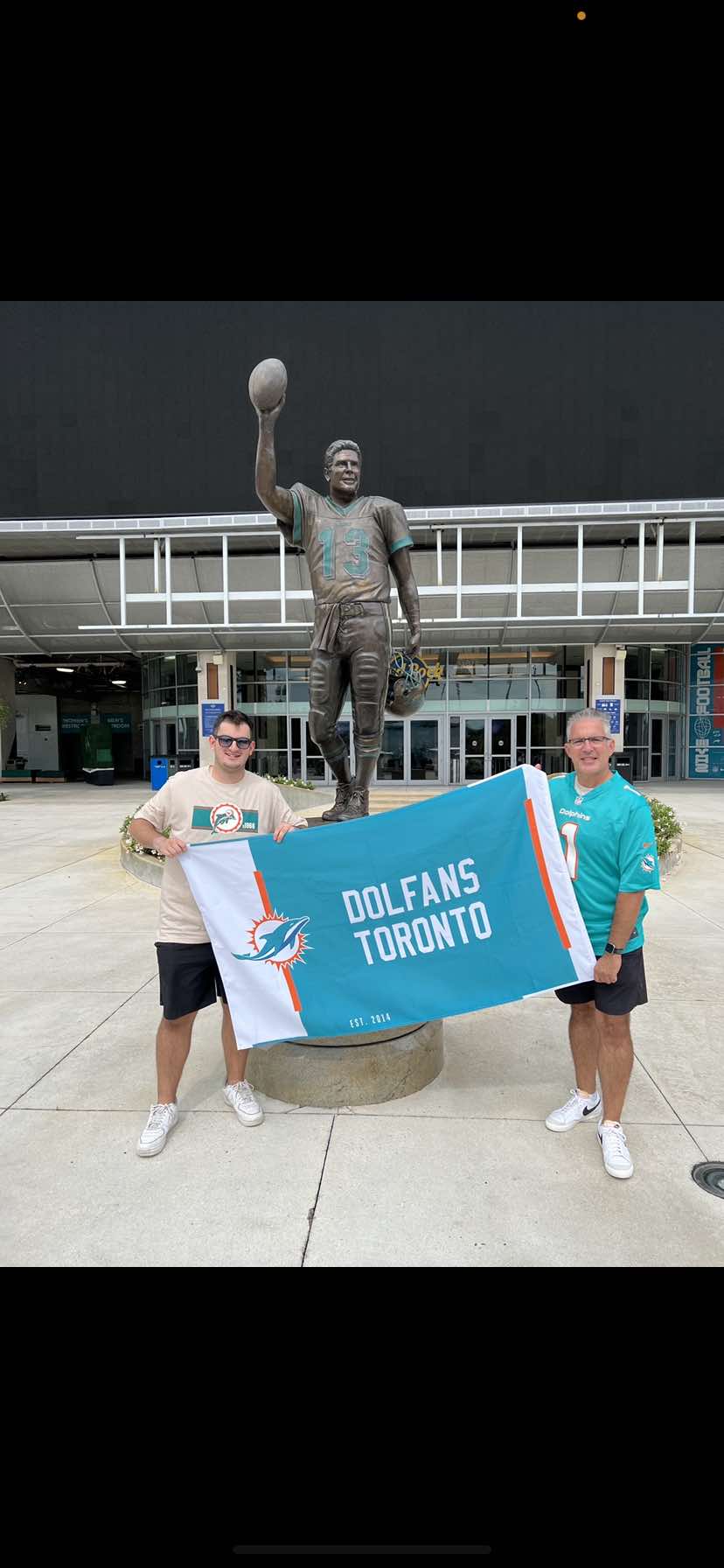 Dolfans Toronto showing club flag in front of Dolphins stadium